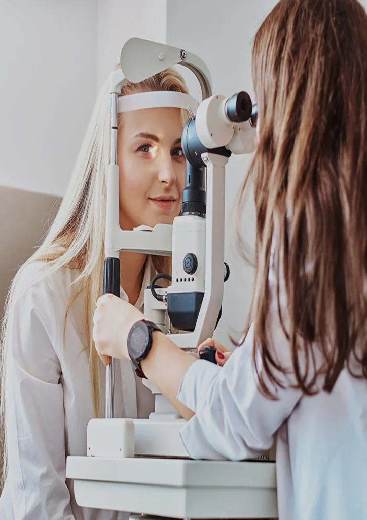 Doctor conducts an eye exam on a woman in an ophthalmology setting