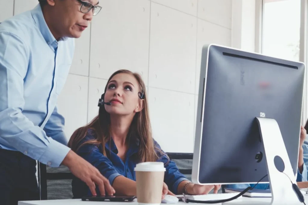 Man and woman collaborate on a computer in an office, focusing on strategies to reduce medical billing errors